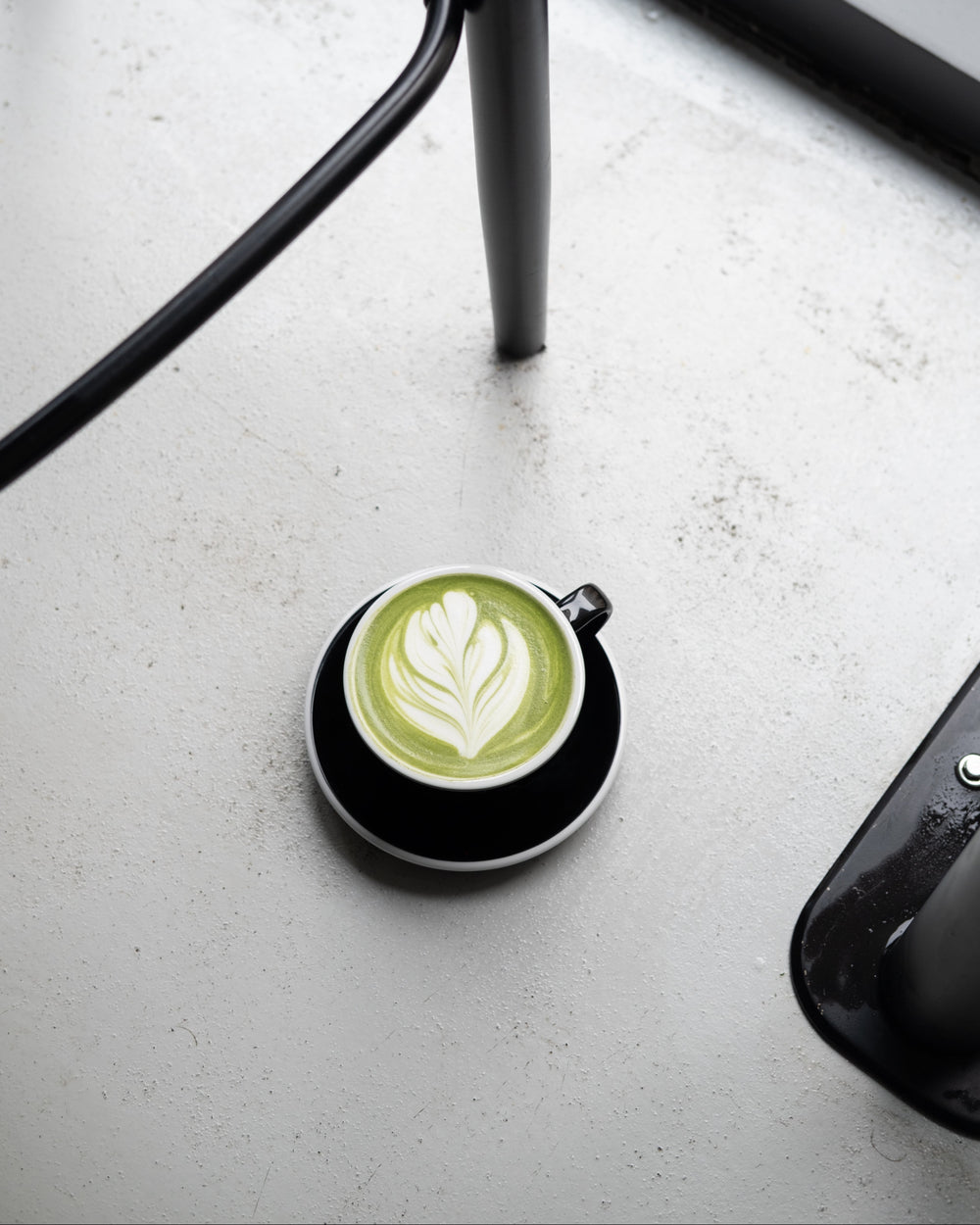 Cup of matcha latter design on a white surface